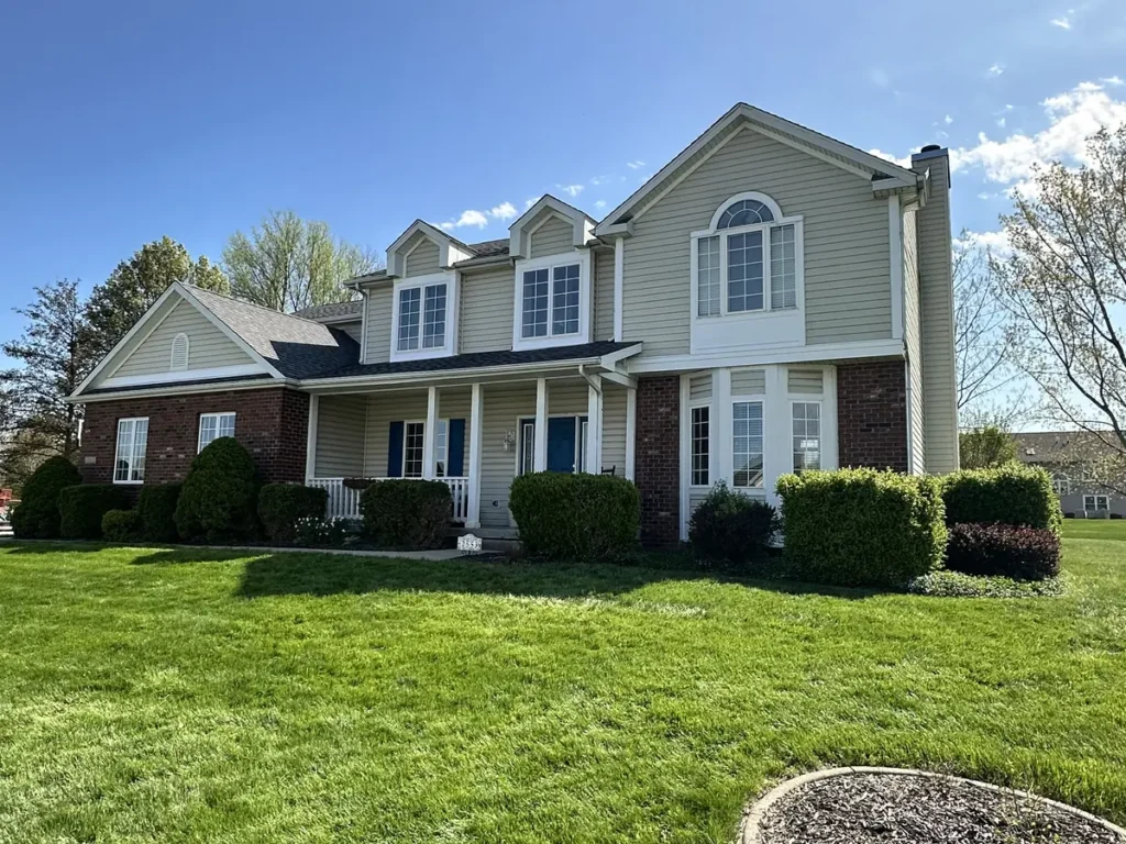 White-trimmed windows and an arched upper window on a two-story Lafayette home