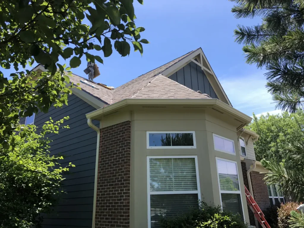White-trimmed windows with transoms beside blue siding and brick on a Westfield home